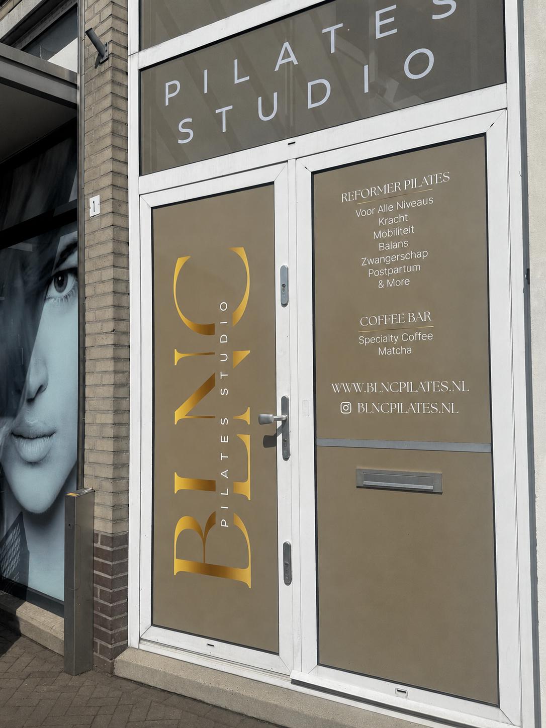 Voordeur van BLNC Pilates Studio met goud logo en signage